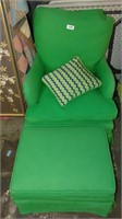 green fabric armchair with footstool