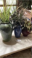 Three artificial plants with nice vases