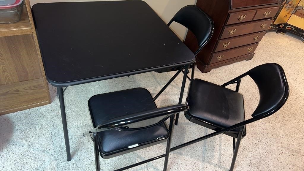 Folding table with 3 chairs.  Cabinet not