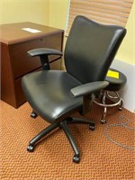 Black leather office chair on wheels