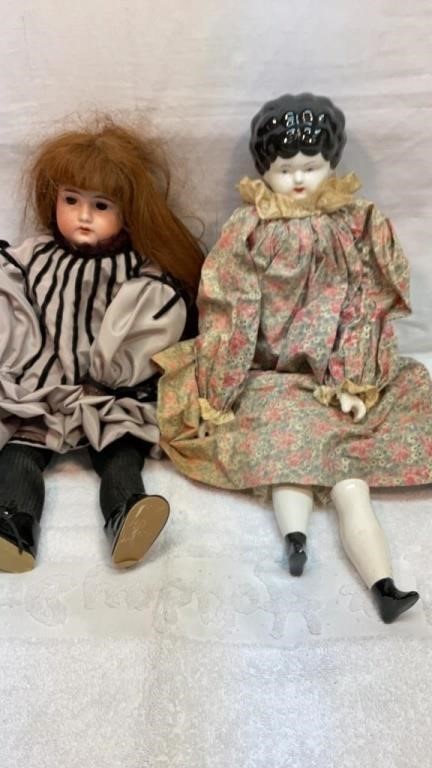 Old porcelain doll and younger sister