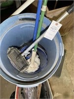 TRASH CAN WITH MULTIPLE MOPS BROOMS ETC