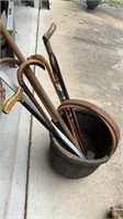 Large woven basket with six walking canes