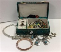 Oriental jewelry box filled with costume jewelry.