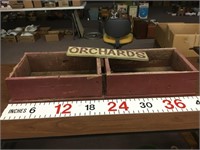 Red wooden flower boxes and orchard sign