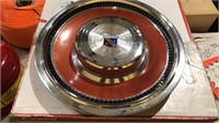 Set of four burnt orange wheel covers for a Buick