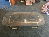 Glass and metal coffee table. 53 wide inches by