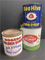 Three vintage syrup and honey cans. Rogers’