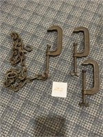 Three metal C clamps with chain