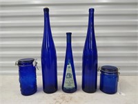 Asst cobalt blue glass, tall bottles are 19"