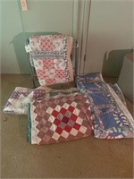 Several Quilts and quilt stand