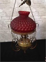 Hanging vintage oil lamp with glass red shade