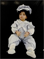 Beautiful porcelain doll with striped chambray ove