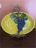 Large decorative yellow platter with raised grape