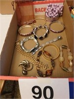 Flat full of bracelets, necklace and 1 pin