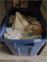 Tote of assorted table cloths, more (dining room)