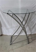 Oval glass and steel side table.  42×36×24