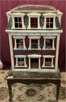 Vintage child’s dollhouse on table