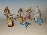 Set of clown dolls riding bikes