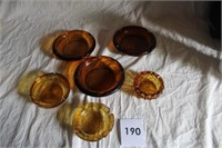 6 AMBER ASH TRAYS - 1 IS FENTON