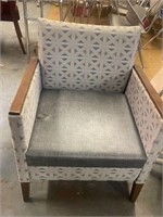 tan and brown patterned cloth chair no arms