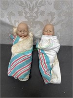 2 newborn dolls with armtags in baby blankets