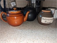 Stoneware teapot, covered jar & retirement fund
