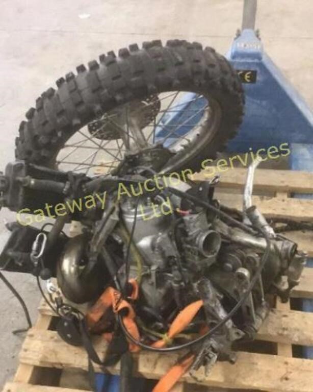 Yamaha dirt bike motor and wheel.