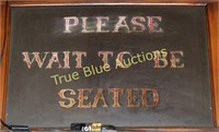 Please wait to be seated sign