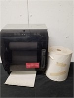 Paper towel dispenser with a roll of paper towels