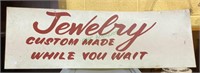 Vintage metal sign that says "Jewelry custom-made