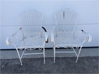 2 white metal chairs