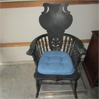 Antique rocking chair w/ claw arm rests.