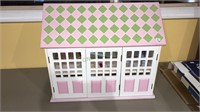 Children’s dollhouse with furniture and dolls and