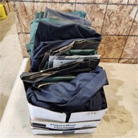 Various sizes of work pants, shirts, etc