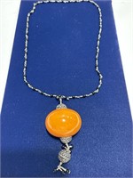 French Bakelite necklace - orange charm measures