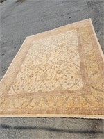 Wool rug cream color ground with floral design.