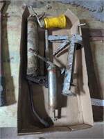 Flat of grease guns and a caulk gun