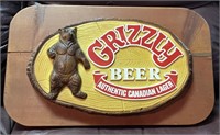 Grizzly Canadian Lager beer sign on wood base.