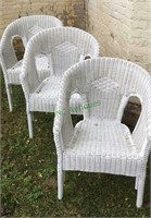 Lawn furniture - a lot of three wicker arm chairs.