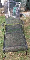 Lawn furniture - one black rod iron recliner.