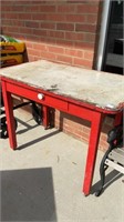 Old red work table, metal top, has drawer, 42x25