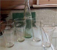 Coke bottle and 4 glasses, bottle from Flint MI