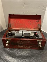Electric Milwaukee sawzall with metal box