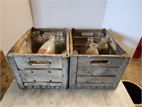 Two Wooden Milk Crates with assorted Milk Bottles.