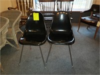 two black molded plastic chairs