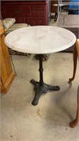 Table with marble top and cast-iron base 25 1/2”