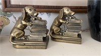Vintage puppy dog bookends with a stack of books.
