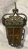 Antique iron hanging light fixture with amber