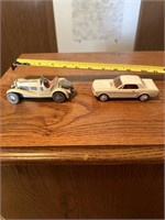 2 toy cars, both metal